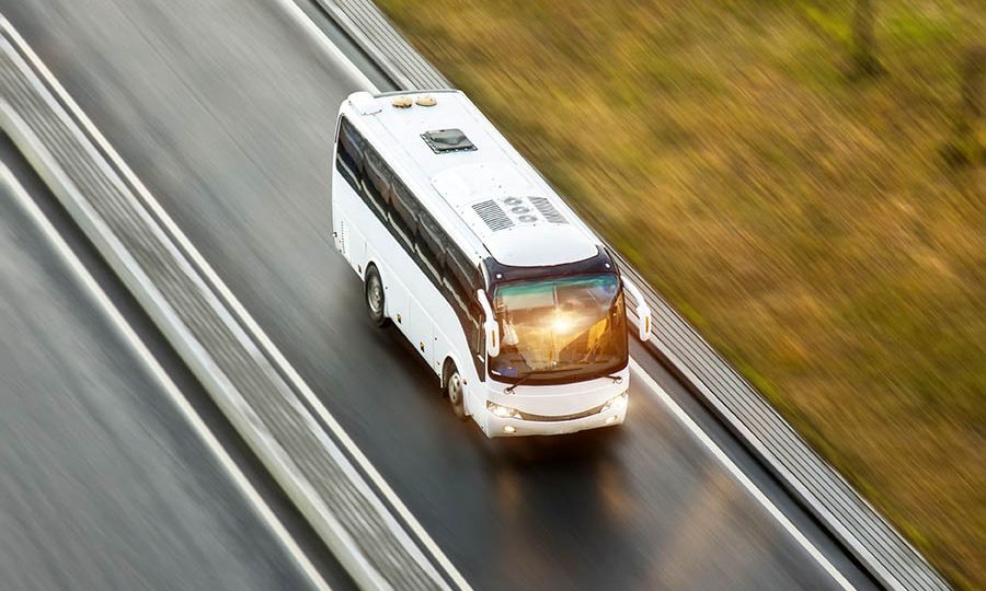 Tourist bus spee ride on highway, blured in motion.