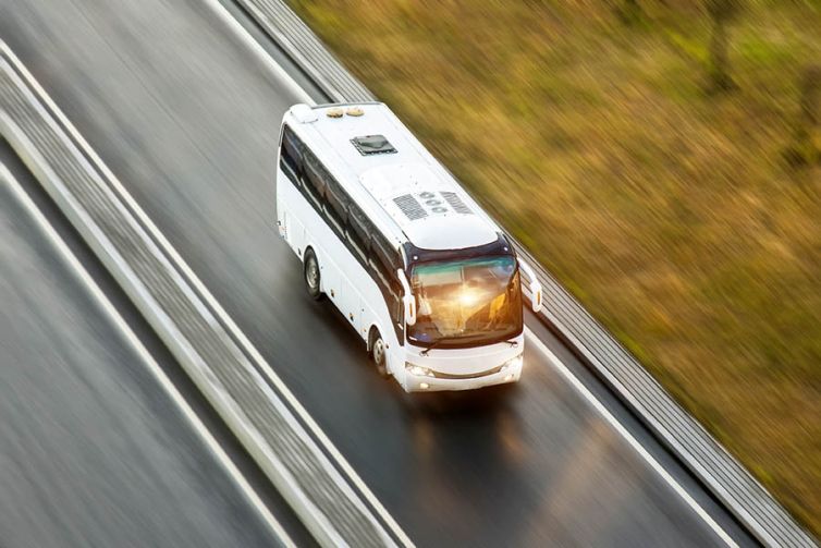 Tourist bus spee ride on highway, blured in motion.