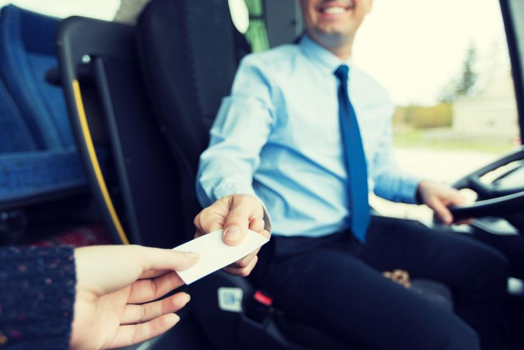 transport-tourism-road-trip-people-concept-close-up-bus-driver-selling-ticket-passenger