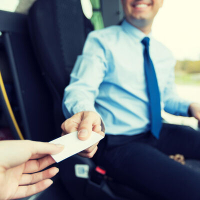 transport-tourism-road-trip-people-concept-close-up-bus-driver-selling-ticket-passenger