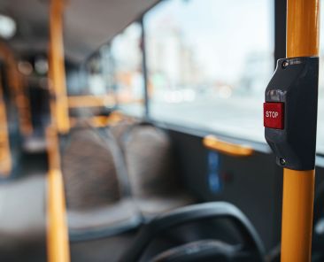 Close-up of handle in empty public bus during COVID-19 pandemic.